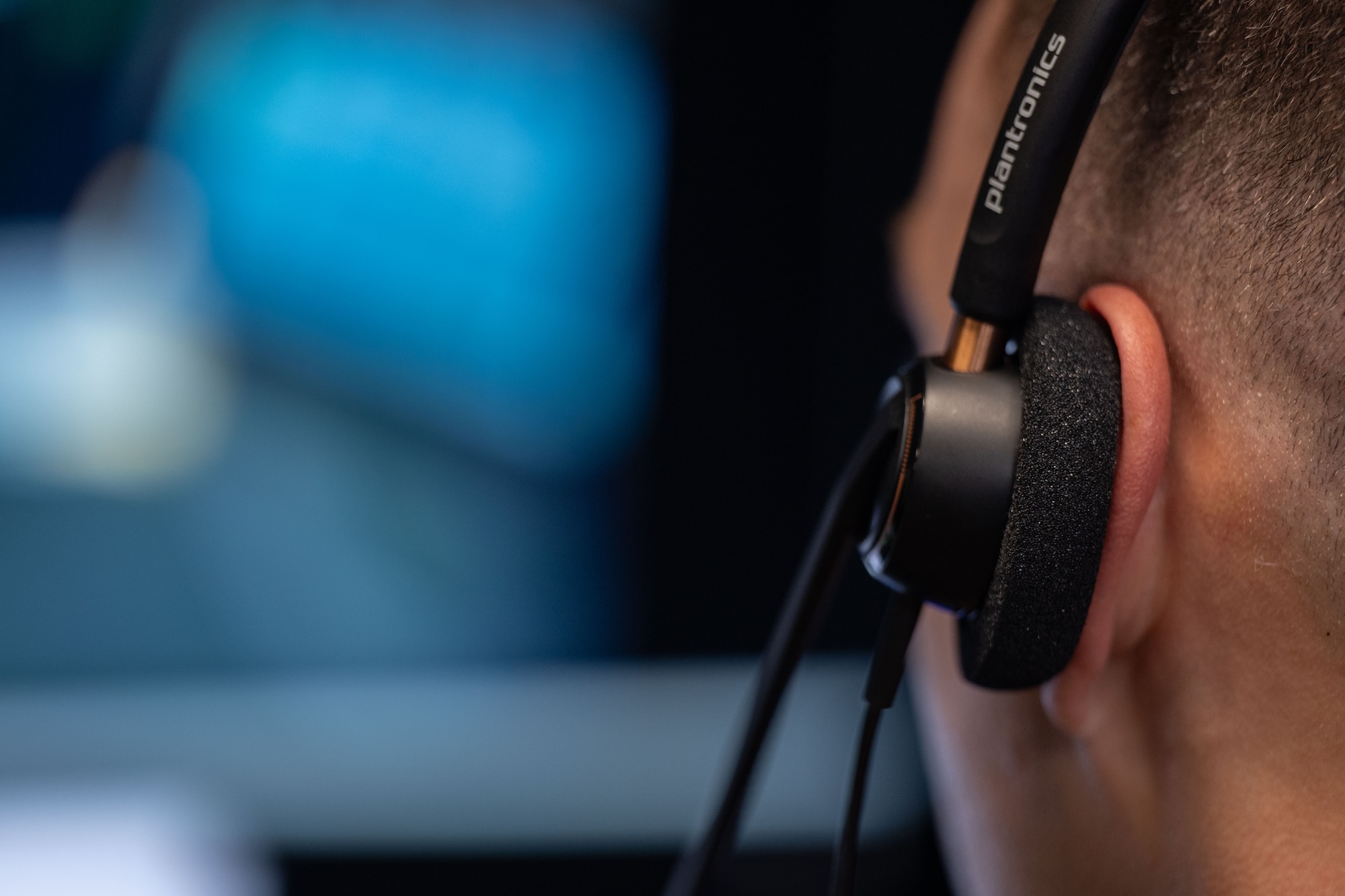 An air traffic controller assigned to the 1st Special Operations Wing wears a communications headset during virtual reality simulation training