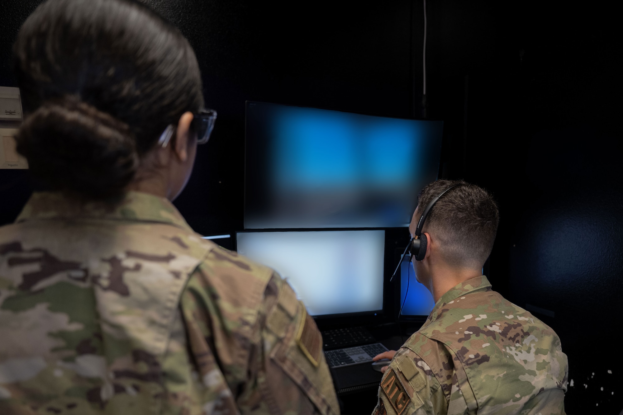 Air traffic controllers assigned to the 1st Special Operations Wing monitor flight line data during virtual reality simulation system training