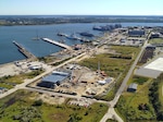 An aerial view of ongoing construction at Coast Guard Base Charleston, where the Coast Guard recently awarded a $230 million contract for new operational support facilities as part of a multi-year infrastructure expansion plan. Recent projects include construction of a 90,000-square-foot engineering complex, a 120,000-square-foot multifunctional building, a new parking structure, recapitalization of Pier Mike, and a new medical and dental facility. These efforts are part of more than $440 million in upgrades to transform Base Charleston into a premier East Coast operational base. (U.S. Coast Guard photo)