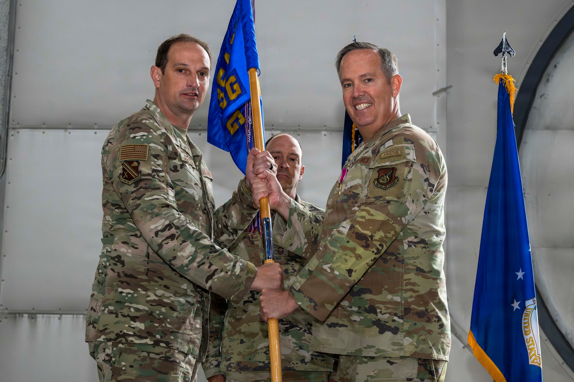 U.S. Air Force Col. Timothy Foster, right, relinquishes command of the 354th Mission Support Group to U.S. Air Force Col. Matthew Johnston, 354th Fighter Group commander, during a change of command ceremony at Eielson Air Force Base, Alaska, July 9, 2026.