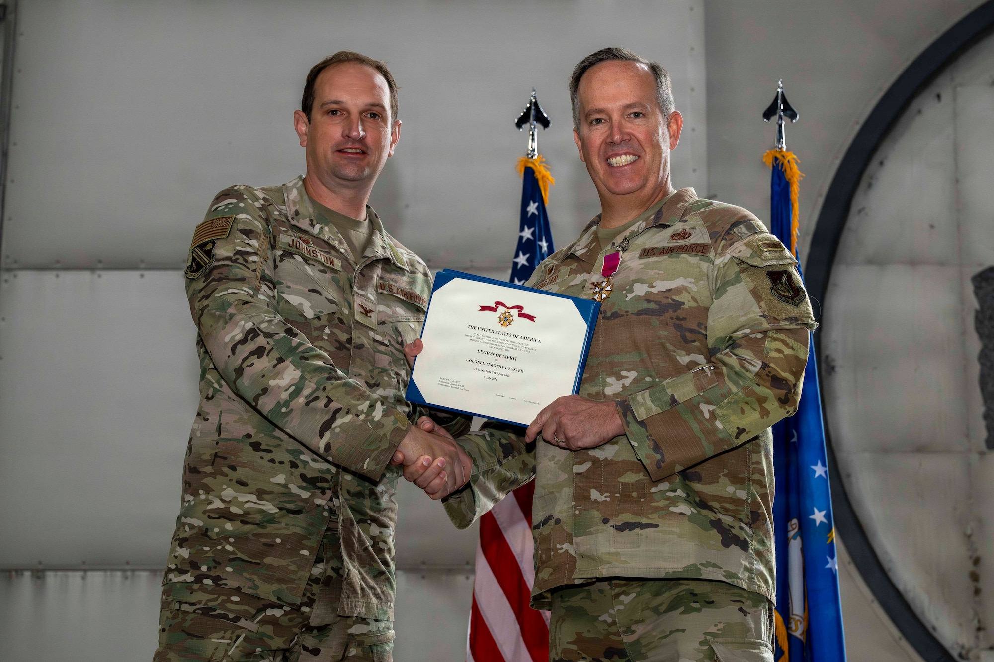 U.S. Air Force Col. Timothy Foster, 354th Mission Support Group commander, right, receives the Meritorious Service Medal from U.S. Air Force Col. Matthew Johnston, 354th Fighter Wing commander, during a change of command ceremony at Eielson Air Force Base, Alaska, July 9, 2026.