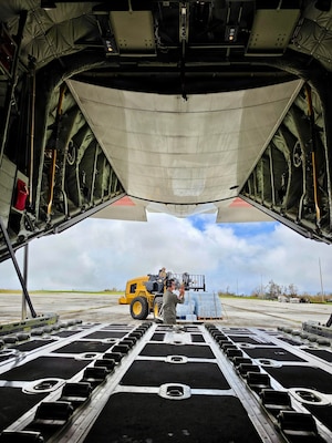 The HC-130J Hercules crew from Air Station Barbers Point in Hawai’i delivers an assessment team and eight pallets of water to Rota, coincident with operations there on July 9, 2026. U.S. Coast Guard crews continue to assess and rectify discrepancies to aids to navigation, waterways, and channel conditions across the Marianas and support the communities following Super Typhoon Bavi. (U.S. Coast Guard photo by Lt. j.g. Nomar Proctor)
