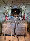 The HC-130J Hercules crew from Air Station Barbers Point in Hawai’i delivers an assessment team and eight pallets of water to Rota, coincident with operations there on July 9, 2026. U.S. Coast Guard crews continue to assess and rectify discrepancies to aids to navigation, waterways, and channel conditions across the Marianas and support the communities following Super Typhoon Bavi. (U.S. Coast Guard photo by Lt. j.g. Nomar Proctor)