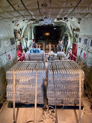 The HC-130J Hercules crew from Air Station Barbers Point in Hawai’i delivers an assessment team and eight pallets of water to Rota, coincident with operations there on July 9, 2026. U.S. Coast Guard crews continue to assess and rectify discrepancies to aids to navigation, waterways, and channel conditions across the Marianas and support the communities following Super Typhoon Bavi. (U.S. Coast Guard photo by Lt. j.g. Nomar Proctor)