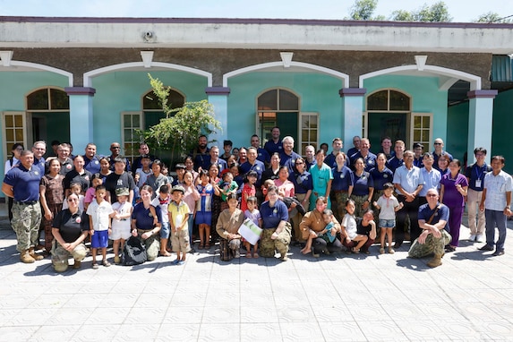Pacific Partnership 2026 (PP26) and Pacific Friendship 2026 (PF26) personnel pose for a photo with children and staff at the Gio Linh Center for Rehabilitation of Children with Disabilities in Quang Tri, Vietnam, during a PP26 community outreach and engagement event, June 24, 2026.