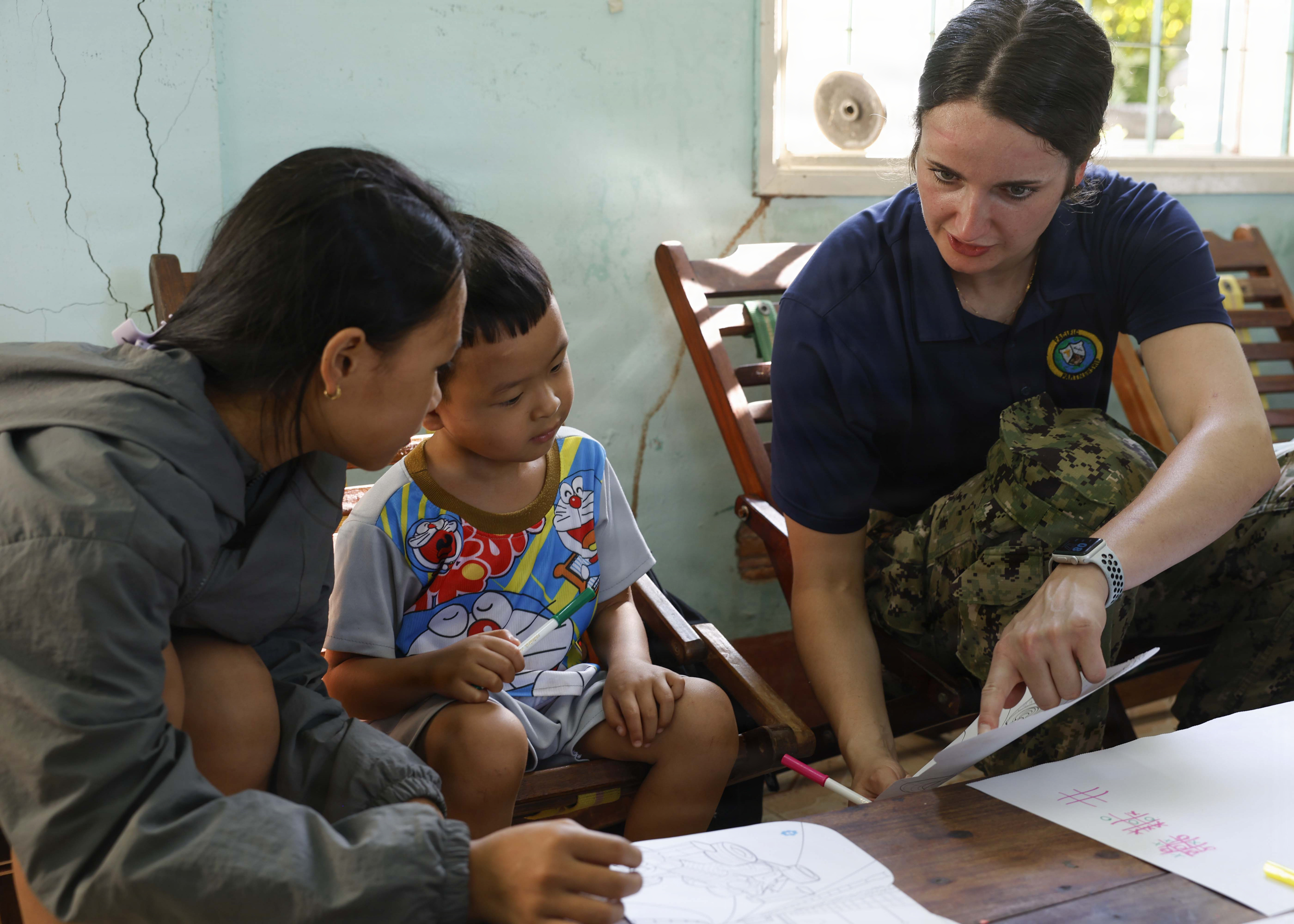 U.S. Navy Lt. Danielle Reinald, right, assigned to Pacific Partnership 2026 (PP26), draws pictures with children during a PP26 community outreach and engagement event at the Gio Linh Center for Rehabilitation of Children with Disabilities in Quang Tri, Vietnam, June 24, 2026.