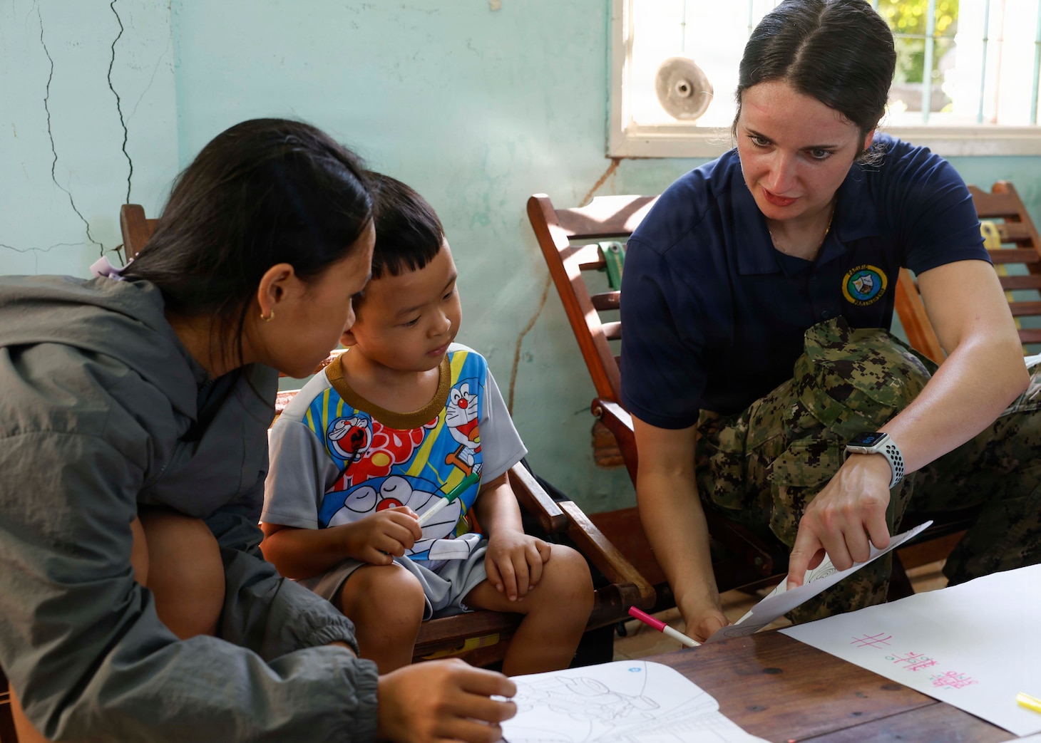 U.S. Navy Lt. Danielle Reinald, right, assigned to Pacific Partnership 2026 (PP26), draws pictures with children during a PP26 community outreach and engagement event at the Gio Linh Center for Rehabilitation of Children with Disabilities in Quang Tri, Vietnam, June 24, 2026.