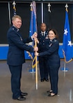 Maj. Gen. (Dr.) Robert K. Bogart (left), Director, Defense Health Network Central, and Commander, Medical Readiness Command Alpha, passes the guidon to Col. Tracy Bozung, 59th Medical Wing commander, at the 59th MDW change of command ceremony at Joint Base San Antonio-Lackland on July 8, 2026. Bozung assumed command of the 59th MDW from Brig. Gen. Gwendolynn A. Foster. (U.S. Air Force photo by Senior Airman Matthew-John Braman)