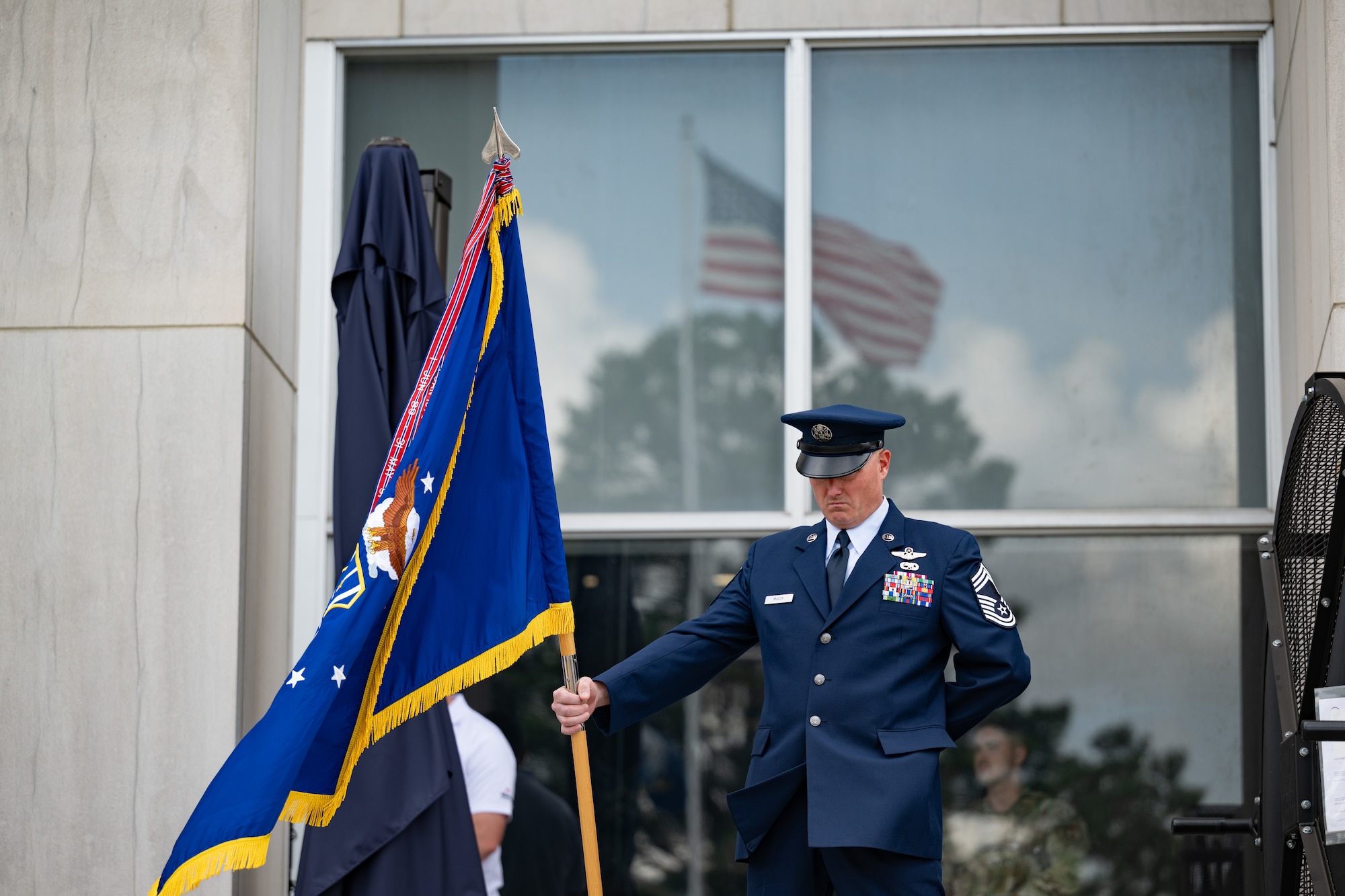 Arnold Engineering Development Complex Senior Enlisted Leader Chief Master Sgt. Evan McCoy holds the AEDC guidon during the AEDC Change of Command ceremony that took place June 27, 2026, as part of the AEDC 75th anniversary open house celebration at Arnold Air Force Base, Tenn., headquarters of AEDC. Outgoing AEDC Commander Col. Grant Mizell relinquished command of the Complex to incoming Commander Col. Wayne Dirkes. (U.S. Air Force photo by Keith Thornburgh)