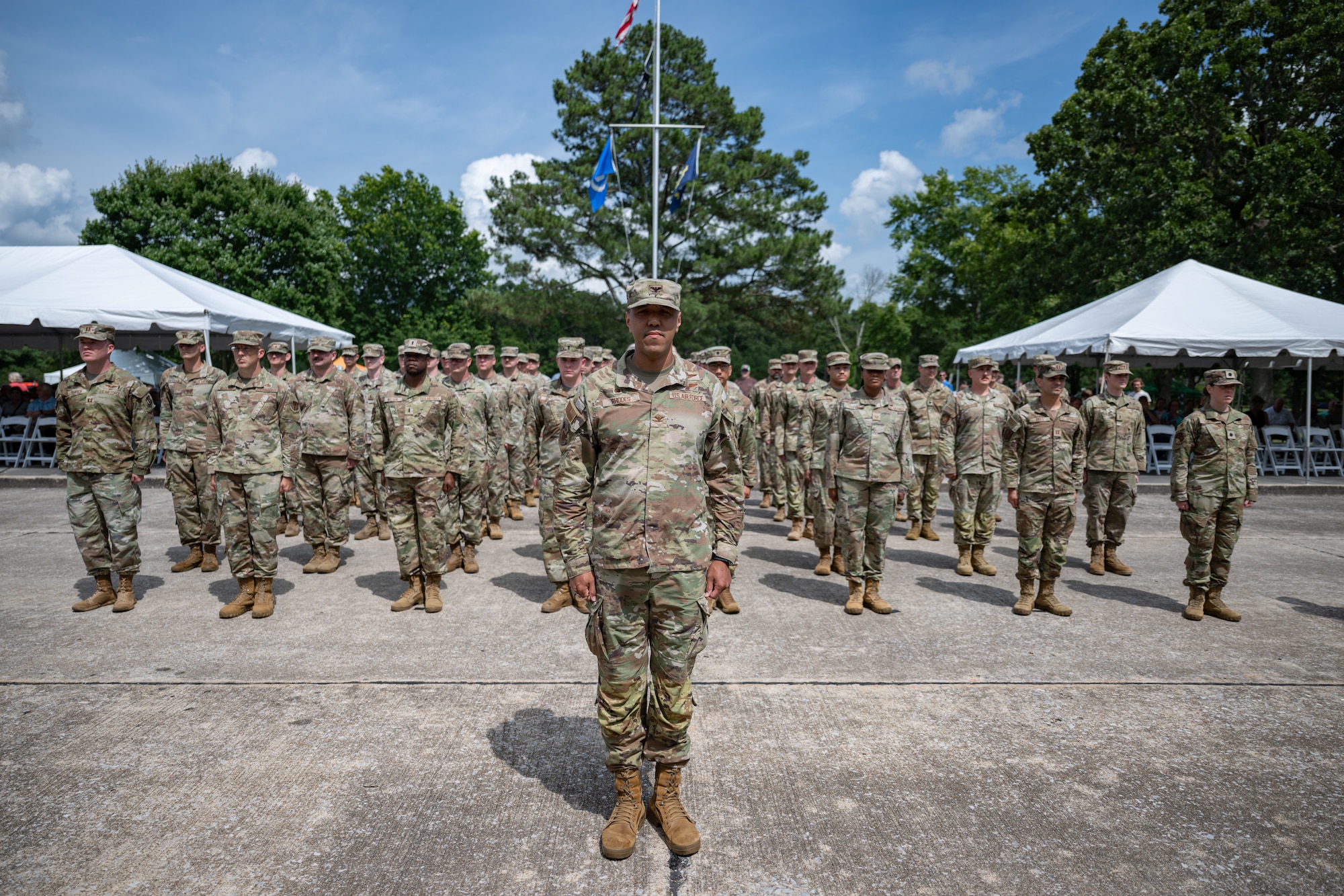 Airmen, led by 804th Test Group Commander Col. Jack Rhodes, center, stand at attention during the Arnold Engineering Development Complex Change of Command ceremony that took place June 27, 2026, as part of the AEDC 75th anniversary open house celebration at Arnold Air Force Base, Tenn., headquarters of AEDC. Outgoing AEDC Commander Col. Grant Mizell relinquished command of the Complex to incoming Commander Col. Wayne Dirkes. (U.S. Air Force photo by Keith Thornburgh)