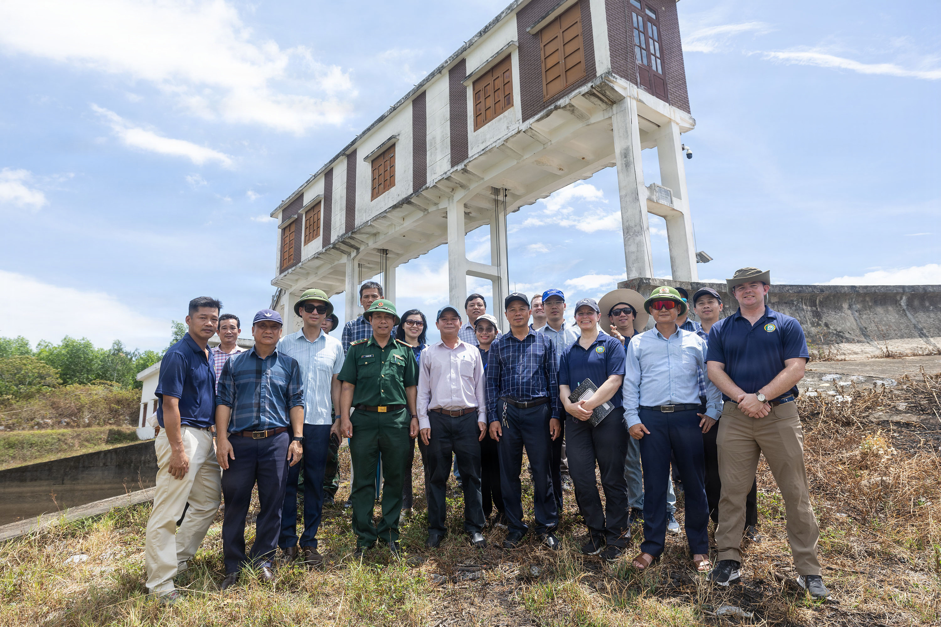 Servicemembers assigned to Pacific Partnership 2026 (PP26) and Quang Tri Sub-department of Irrigation and Disaster Prevention members pose for a photo at Phu Vinh reservoir during a PP26 disaster management field training exercise in Quang Tri, Vietnam, July 2, 2026.