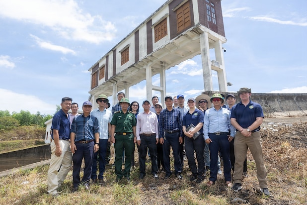 Servicemembers assigned to Pacific Partnership 2026 (PP26) and Quang Tri Sub-department of Irrigation and Disaster Prevention members pose for a photo at Phu Vinh reservoir during a PP26 disaster management field training exercise in Quang Tri, Vietnam, July 2, 2026.