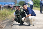 Vietnam People’s Armed Forces Lt. Col. Trần Hữu Tuấn, left, assigned to Quang Tri Provincial Military Command, poses for a photo with U.S. Army Master Sgt. Tony Dang, right, Civil Affairs team sergeant assigned to Pacific Partnership 2026 disaster management workshop during a PP26 disaster management field training exercise in Quang Tri, Vietnam, July 2, 2026.