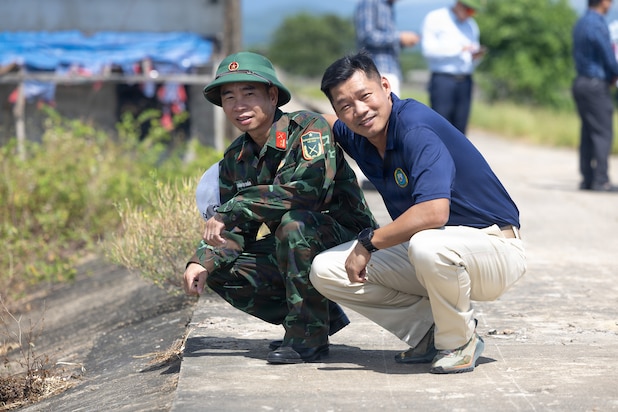 Vietnam People’s Armed Forces Lt. Col. Trần Hữu Tuấn, left, assigned to Quang Tri Provincial Military Command, poses for a photo with U.S. Army Master Sgt. Tony Dang, right, Civil Affairs team sergeant assigned to Pacific Partnership 2026 disaster management workshop during a PP26 disaster management field training exercise in Quang Tri, Vietnam, July 2, 2026.