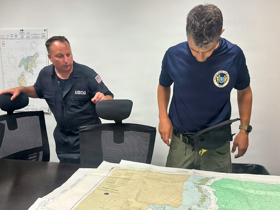 A U.S. Coast Guard dive team from the Regional Dive Locker in Honolulu works operational planning to address affected aids to navigation in the Commonwelath of the Northern Mariana Islands, on July 10, 2026. U.S. Coast Guard crews continue to assess and rectify discrepancies to aids to navigation, waterways, and channel conditions across the Marianas following Super Typhoon Bavi. (U.S. Coast Guard photo by Lt. Gabe LaMartina)
