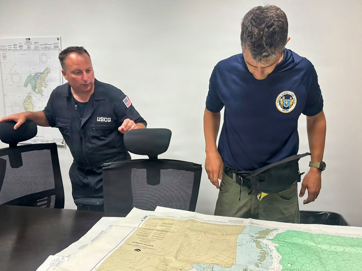 A U.S. Coast Guard dive team from the Regional Dive Locker in Honolulu works operational planning to address affected aids to navigation in the Commonwelath of the Northern Mariana Islands, on July 10, 2026. U.S. Coast Guard crews continue to assess and rectify discrepancies to aids to navigation, waterways, and channel conditions across the Marianas following Super Typhoon Bavi. (U.S. Coast Guard photo by Lt. Gabe LaMartina)