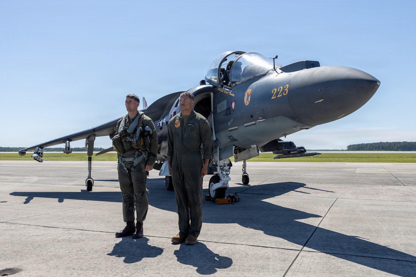 U.S. Marine Corps Lt. Col. John B. Cumbie, left, a native of Texas and the commanding officer of Marine Attack Squadron (VMA) 223, Marine Aircraft Group 14, 2nd Marine Aircraft Wing and Cpl. Myles J. Howard a native of Georgia, a fixed-wing aircraft mechanic with VMA-223, stand at attention in front of an AV-8B Harrier II at Marine Corps Air Station Cherry Point, June 3, 2026. The “sundown” of the AV-8B Harrier II, an iconic aircraft that has supported joint and Marine Corps operations for over 40 years, also represents the dawn of a new era; it paves the way for 2nd MAW’s full transition to the F-35B and C Lightning II. VMA-223 is the U.S. Marine Corps' last operational Harrier squadron.