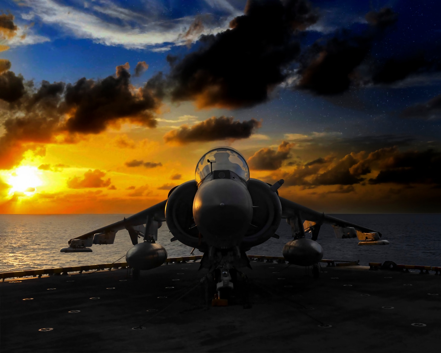 An AV-8B Harrier II, attached to Marine Medium Tiltrotor Squadron (VMM) 163 (Reinforced) rests on the flight deck elevator of amphibious assault ship USS Boxer (LHD 4), Oct.25, 2019.