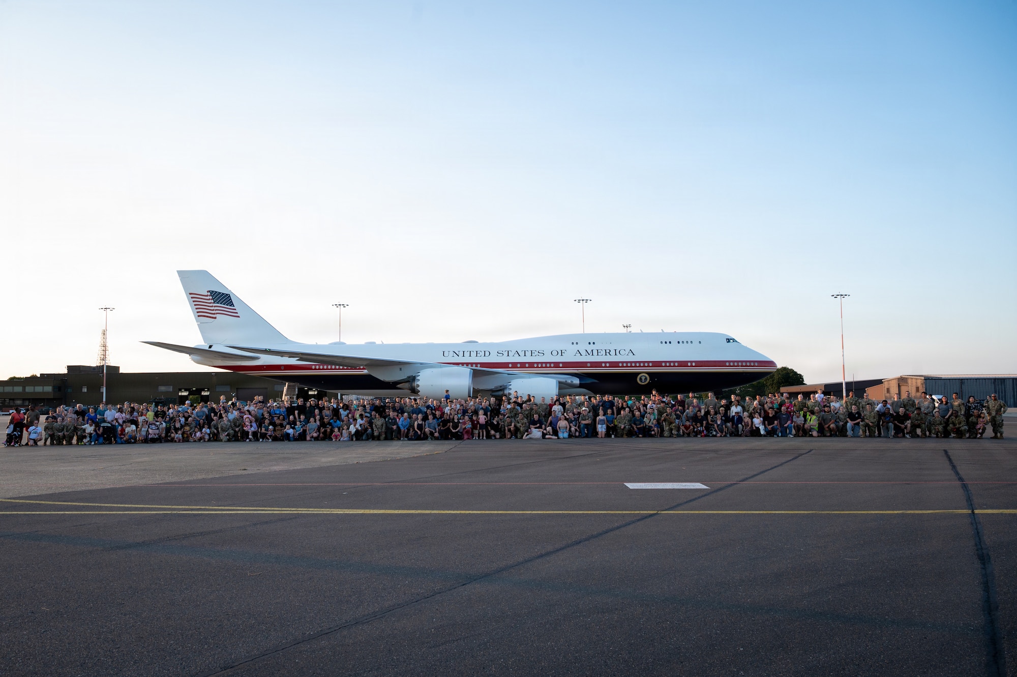 Team Mildenhall members pose during the viewing of the Air Force’s VC-25B Bridge aircraft on the flightline at RAF Mildenhall, England, July 8, 2026.