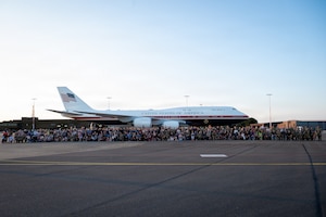 Team Mildenhall members pose during the viewing of the Air Force’s VC-25B Bridge aircraft on the flightline at RAF Mildenhall, England, July 8, 2026.