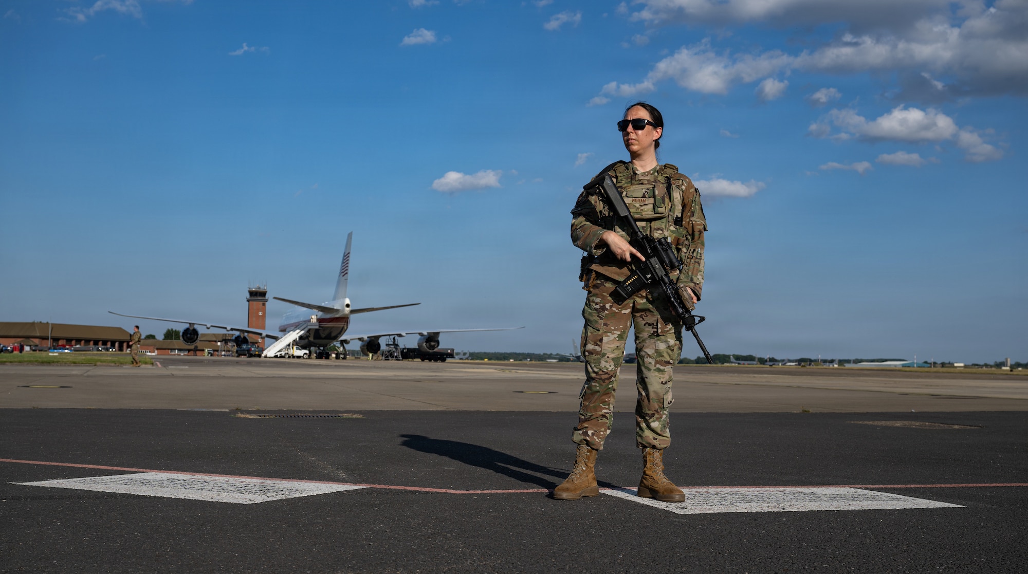 U.S. Air Force Senior Airman Katherine Moran, 100th Security Forces Squadron defender, guards the Air Force’s VC-25B Bridge aircraft at RAF Mildenhall, England, July 8, 2026.