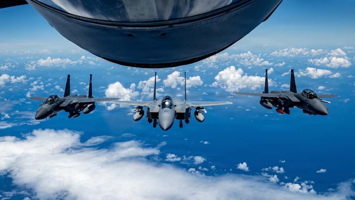 U.S. Air Force aircraft including an F-15EX Eagle II, center, and two F-15E Strike Eagles assigned to the 85th Test and Evaluation Squadron fly in formation after receiving fuel from a KC-135 Stratotanker assigned to the 909th Air Refueling Squadron over the Pacific Ocean, June 29, 2026. The aircraft flew to Kadena Air Base, Japan, for integration and familiarization training with local units and joint partners in preparation for the permanent arrival of the F-15EX. (U.S. Air Force photo by Airman 1st Class Arnet Tamayo)