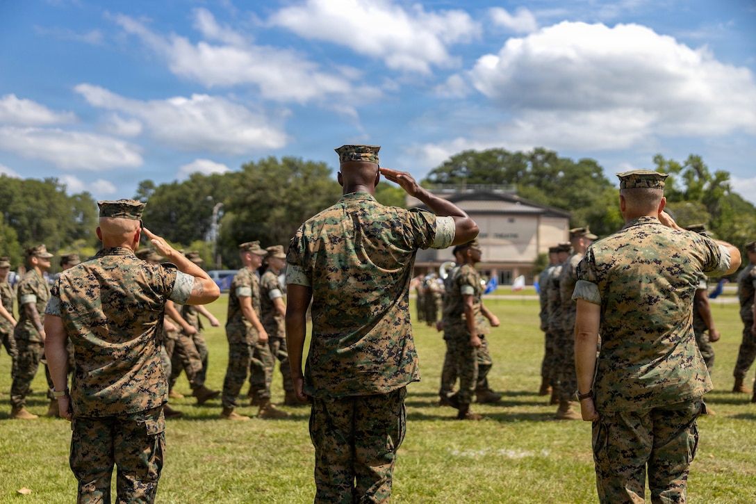 U.S. Marine Corps Sgt. Maj. Bryan M. Alfaro, out-going sergeant major, left, Sgt. Maj. Lacey J. Lewis, in-coming sergeant major, center, and Col. Trevor J. Felter, commanding officer, all with Marine Corps Air Station Beaufort, salute colors during a Relief and Appointment Ceremony at MCAS Beaufort, South Carolina, July 1, 2026. The ceremony recognized Alfaro for his service, leadership and dedication to the unit while welcoming Lewis. (U.S. Marine Corps photo by Cpl. Isabella Renaud)