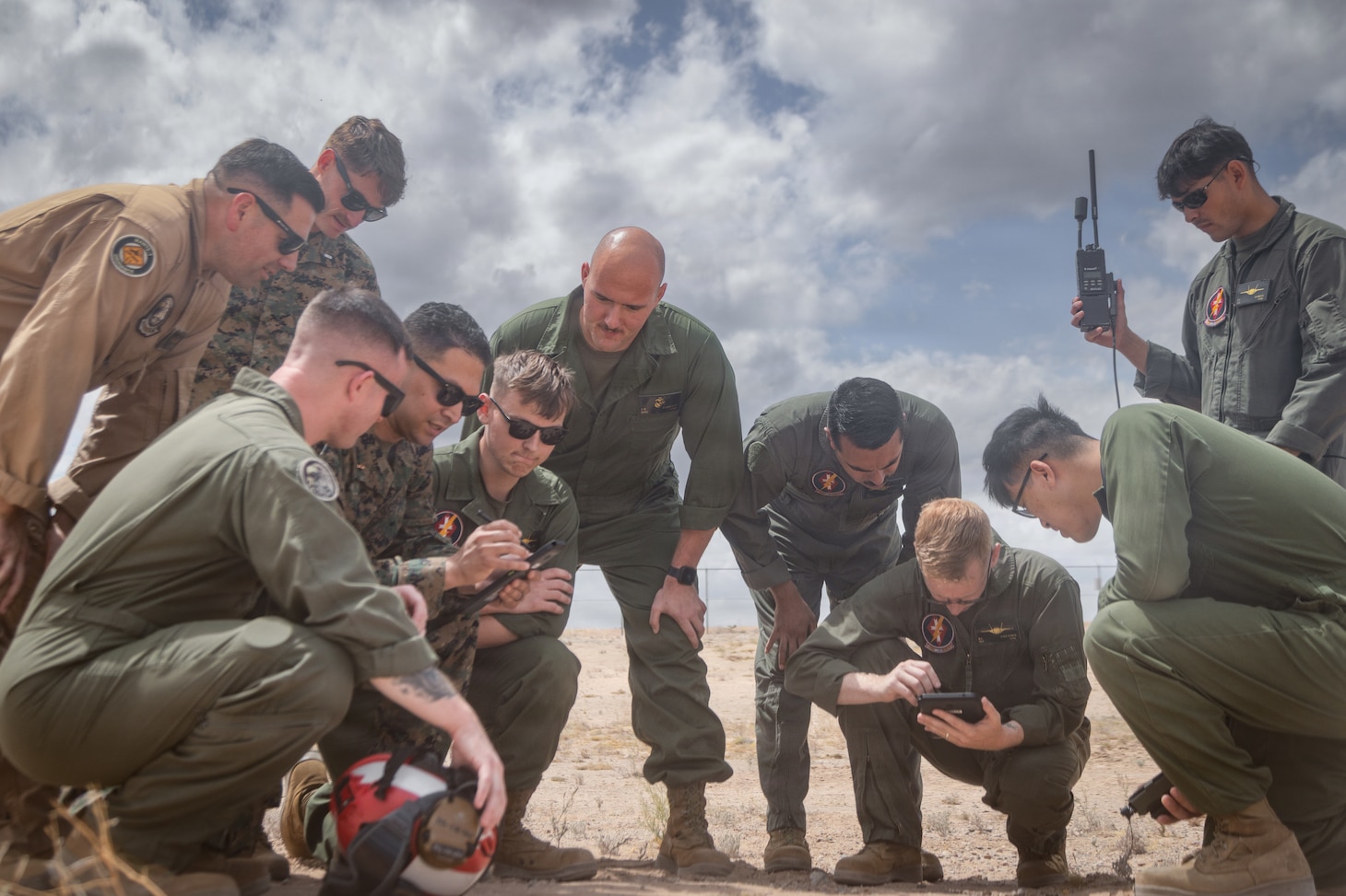 U.S. Marines assigned to Marine Aviation Weapons and Tactics Squadron One (MAWTS-1) have a group discussion as part of Weapons and Tactics Instructor Course 2-26 at Marine Corps Air Station Yuma, Arizona, April 13, 2026. WTI is a seven-week training event hosted by MAWTS-1 which emphasizes operational integration of the seven functions of Marine aviation in support of the Marine Air Ground Task Force, Joint and Coalition Forces.