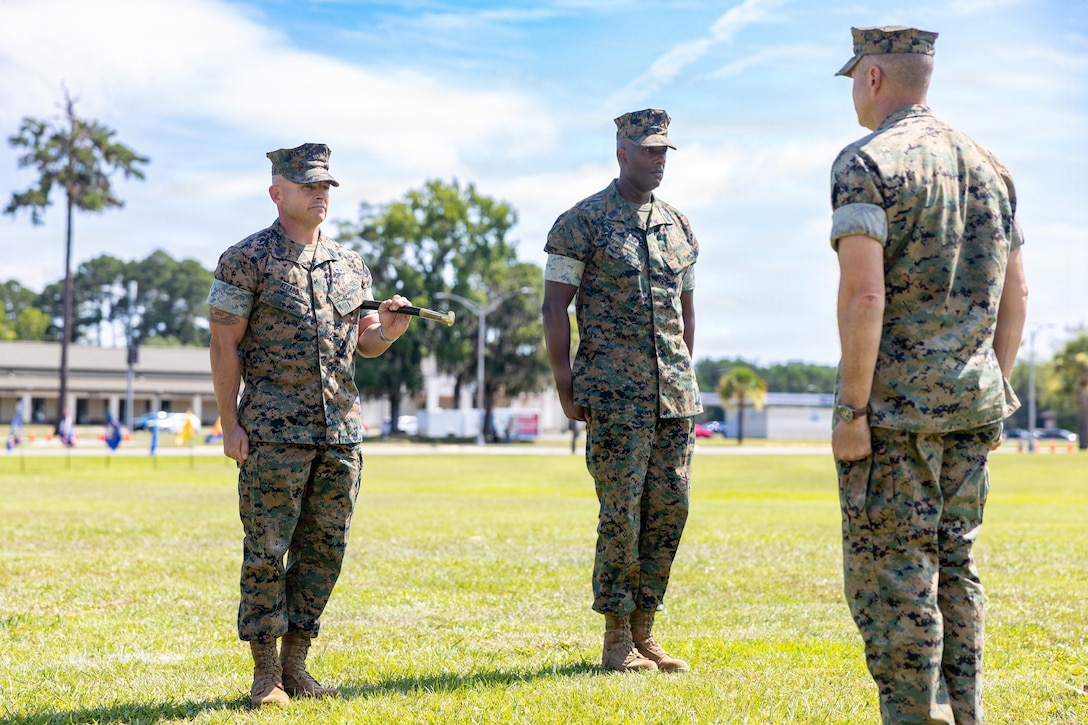 U.S. Marine Corps Sgt. Maj. Bryan M. Alfaro, out-going sergeant major, Marine Corps Air Station Beaufort, left, and Sgt Maj. Lacey J. Lewis, in-coming sergeant major, MCAS Beaufort, stand at attention before the exchange of the command sword during a Relief and Appointment Ceremony at MCAS Beaufort, South Carolina, July 1, 2026. The ceremony recognized Alfaro for his service, leadership and dedication to the unit while welcoming Lewis. (U.S. Marine Corps photo by Cpl. Isabella Renaud)