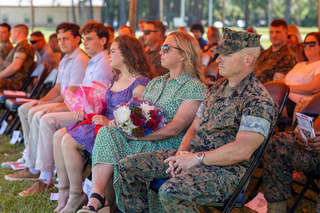 U.S. Marine Corps Sgt. Maj. Bryan M. Alfaro, out-going sergeant major, Marine Corps Air Station Beaufort, sits with friends and family during a Relief and Appointment Ceremony at MCAS Beaufort, South Carolina, July 1, 2026. The ceremony recognized Alfaro for his service, leadership and dedication to the unit while welcoming in-coming Sgt. Maj. Lacey J. Lewis. (U.S. Marine Corps photo by Cpl. Isabella Renaud)