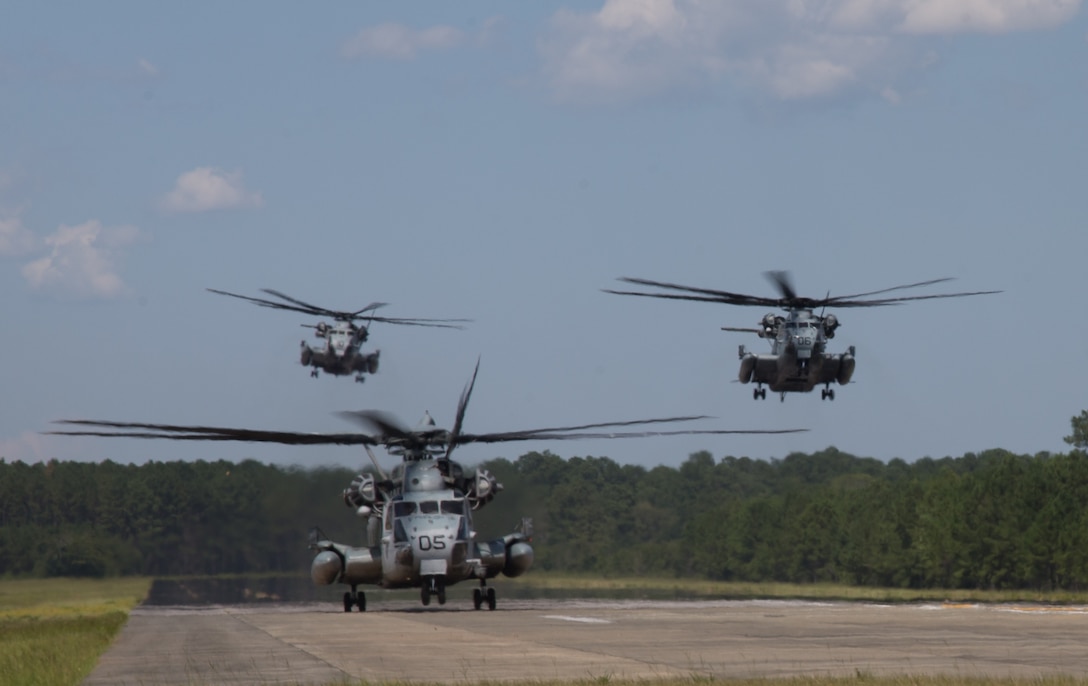 U.S. Marine Corps CH-53E Super Stallions with Marine Heavy Helicopter Training Squadron (HMHT)-302, land at Marine Corps Air Station New River, North Carolina, July 29, 2019. HMHT-302 and Marine Heavy Helicopter Squadron-461 are conducting an assault support movement; transporting over 500 Marines. Operations like these are necessary to the 2nd Marine Aircraft Wing in order to maintain a constant state of readiness. (U.S. Marine Corps photo by Cpl. Paige C. Stade)