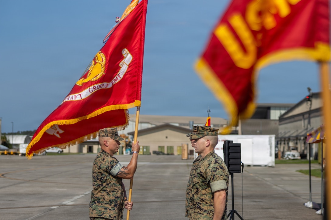 U.S. Marine Corps SgtMaj. Nicholas C. Elliott, left, Marine Aircraft Group 31, 2nd Marine Aircraft Wing passes the guidon to Col. Clayton Gard III, in-coming commanding officer, MAG-31, 2nd MAW, during a Change of Command ceremony at Marine Corps Air Station Beaufort, South Carolina, June 26, 2026. The ceremony recognized Col. Michael R. Cassidy for his service, leadership and dedication to the unit while welcoming Gard. (U.S. Marine Corps photo by Lance Cpl. Carl J. Walters)