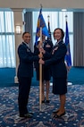 A photo of Air Force Col. and lt. Col. holding a guidon facing the camera.