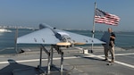 Nick Fancher, a Shipboard Weapons Integration Team weapons logistics analyst, and Rob Pavel, a logistician with Naval Air Warfare Center Weapons Division, conduct shipboard weapons integration work in support of the Low-cost Unmanned Combat Attack System aboard USS Santa Barbara (LCS 32). SWIT validates that weapons systems can be safely stored, moved, and handled at sea prior to operational use. LUCAS later successfully launched from the ship’s flight deck Dec. 16, 2025, as part of Task Force Scorpion Strike operations while operating in the Arabian Gulf.