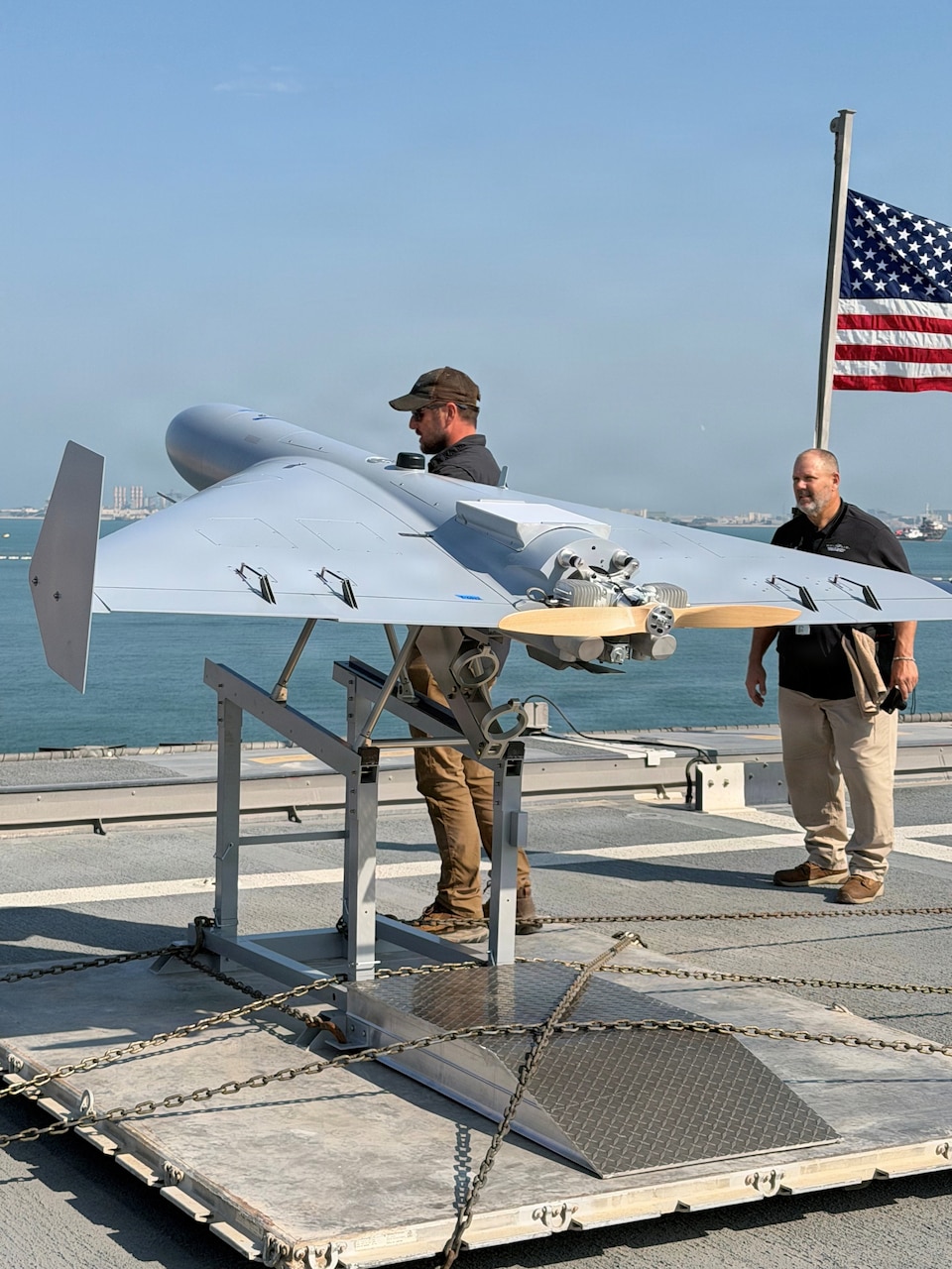 Nick Fancher, a Shipboard Weapons Integration Team weapons logistics analyst, and Rob Pavel, a logistician with Naval Air Warfare Center Weapons Division, conduct shipboard weapons integration work in support of the Low-cost Unmanned Combat Attack System aboard USS Santa Barbara (LCS 32). SWIT validates that weapons systems can be safely stored, moved, and handled at sea prior to operational use. LUCAS later successfully launched from the ship’s flight deck Dec. 16, 2025, as part of Task Force Scorpion Strike operations while operating in the Arabian Gulf.