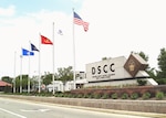 A sign that reads DSCC with flags from 2004.