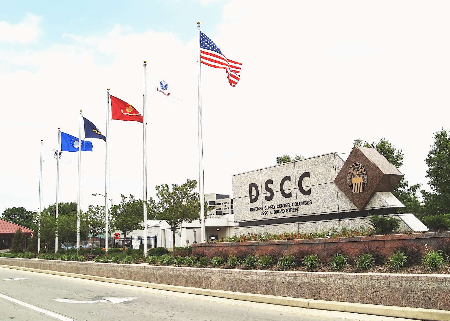 A sign that reads DSCC with flags from 2004.