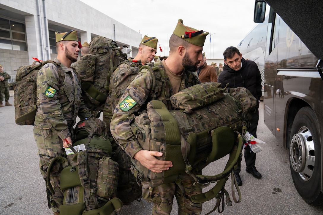 Spanish service members with the Spanish Legion and operating under the NATO Allied Reaction Force (ARF) load their luggage into buses after arriving at Alexandroupolis Airport, Greece, during the Strategic Deployment portion of NATO Exercise Steadfast Dart 2025.