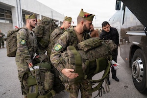 Spanish service members with the Spanish Legion and operating under the NATO Allied Reaction Force (ARF) load their luggage into buses after arriving at Alexandroupolis Airport, Greece, during the Strategic Deployment portion of NATO Exercise Steadfast Dart 2025.