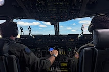 A photo of a pilot flying a C-17 Globemaster III cargo plane