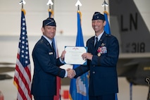 Maj. Gen. Paul D. Moga presents a decoration to Brig. Gen. Jack Arthaud