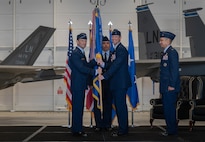 Maj. Gen. Paul D. Moga, Brig. Gen. Jack Arthaud and Col. Michael Alfaro pass the guidon