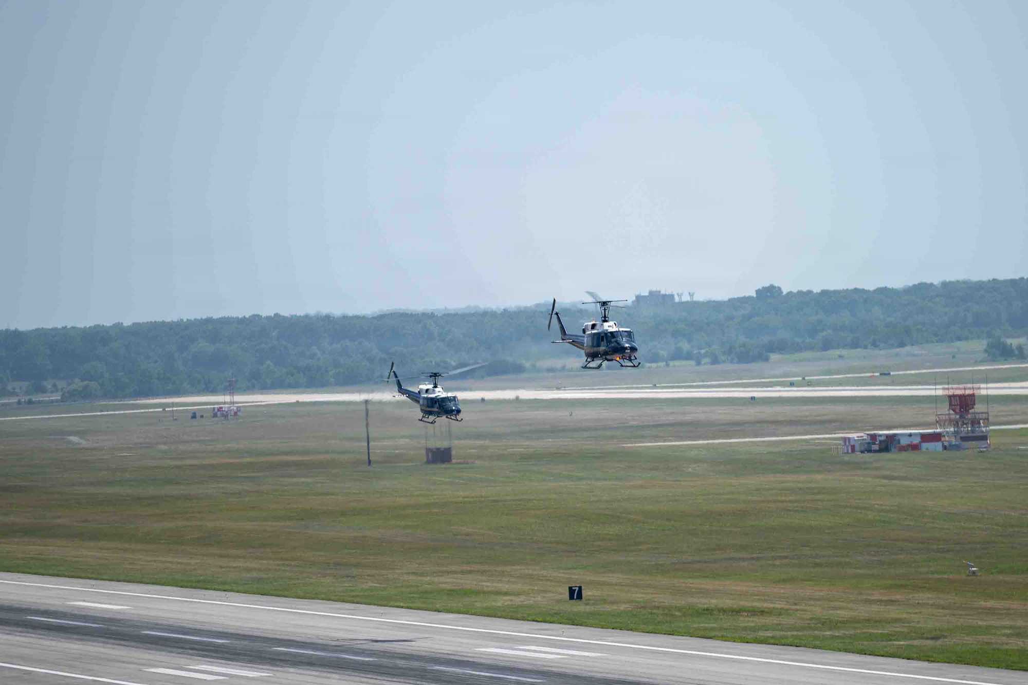 Two UH-1N Hueys assigned to the 1st Helicopter Squadron take off from Joint Base Andrews, Maryland.