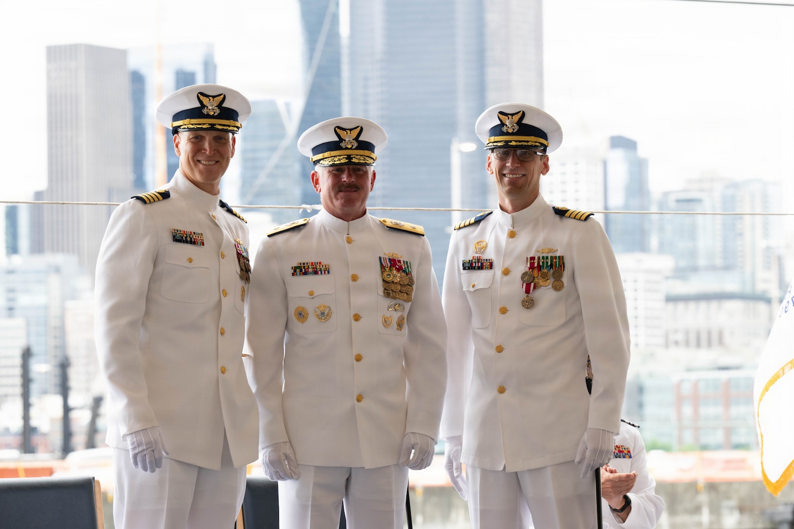 Coast Guard Capt. Justin O. Vanden Heuvel, commanding officer of the USCC Polar Star (WAGB 10) (left), Coast Guard Rear Adm. Jeffrey W. Novak, deputy commander of the Pacific Area (center), and Coast Guard Capt. Jeffrey J. Rasnake (right), pose for a photo during the Polar Star's change-of-command ceremony at U.S. Coast Guard Base Seattle, June 29, 2026. Vanden Heuvel assumed command from Rasnake during the ceremony and previously served as the Leadership Development Center's school chief of command and operations. (U.S. Coast Guard photo by Petty Officer 3rd class Adrian Sanchez Villa)