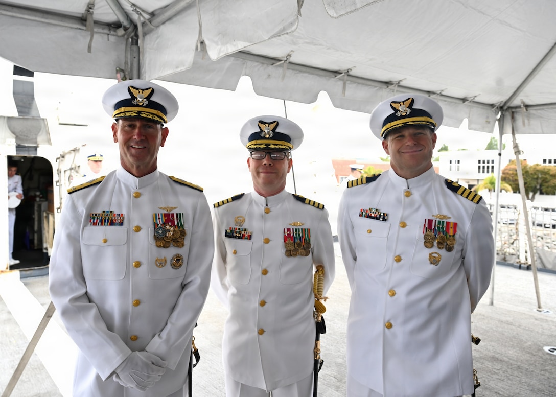 U.S. Coast Guardsmen (l-r), Vice Adm. Joseph R. Buzzella, Capt. Tyson J. Scofield and Capt. Dave W. Ratner, pose for a photo together ahead of the U.S. Coast Guard Cutter Waesche (WMSL 751) change-of-command ceremony on Coast Guard Island in Alameda, California, July 9, 2026. The change-of-command ceremony is a time honored tradition that formally transfers authority, responsibility, and accountability from one commanding officer to another. (U.S. Coast Guard photo by Petty Officer 3rd Class Danish Khan.)