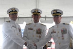 U.S. Coast Guardsmen (l-r), Capt. Dave W. Ratner, Vice Adm. Joseph R. Buzzella, Capt. Tyson J. Scofield, stand together for a photo at the change-of-command ceremony for USCGC Waesche (WMSL 751) at Coast Guard Island in Alameda, California, July 9, 2026. The change-of-command ceremony is a time honored tradition that formally transfers authority, responsibility, and accountability from one commanding officer to another. (U.S. Coast Guard photo by Petty Officer 3rd Class Danish Khan.)