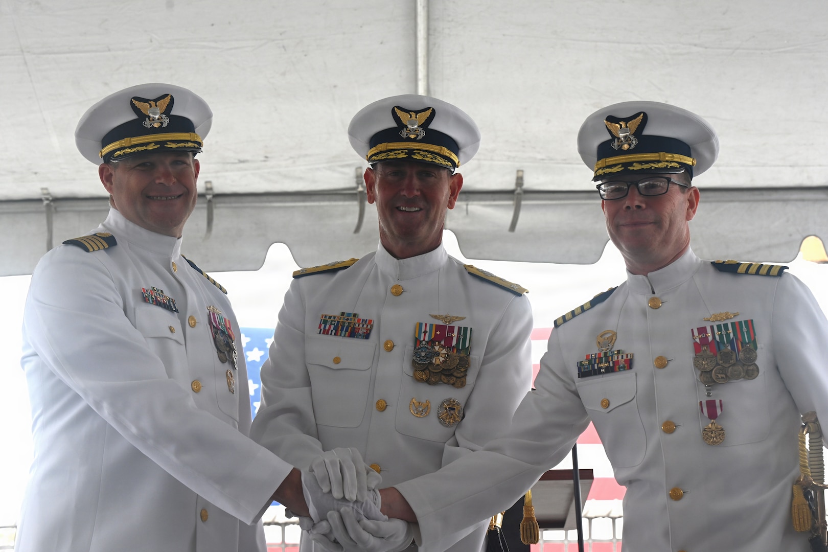 U.S. Coast Guardsmen (l-r), Capt. Dave W. Ratner, Vice Adm. Joseph R. Buzzella, Capt. Tyson J. Scofield, stand together for a photo at the change-of-command ceremony for USCGC Waesche (WMSL 751) at Coast Guard Island in Alameda, California, July 9, 2026. The change-of-command ceremony is a time honored tradition that formally transfers authority, responsibility, and accountability from one commanding officer to another. (U.S. Coast Guard photo by Petty Officer 3rd Class Danish Khan.)