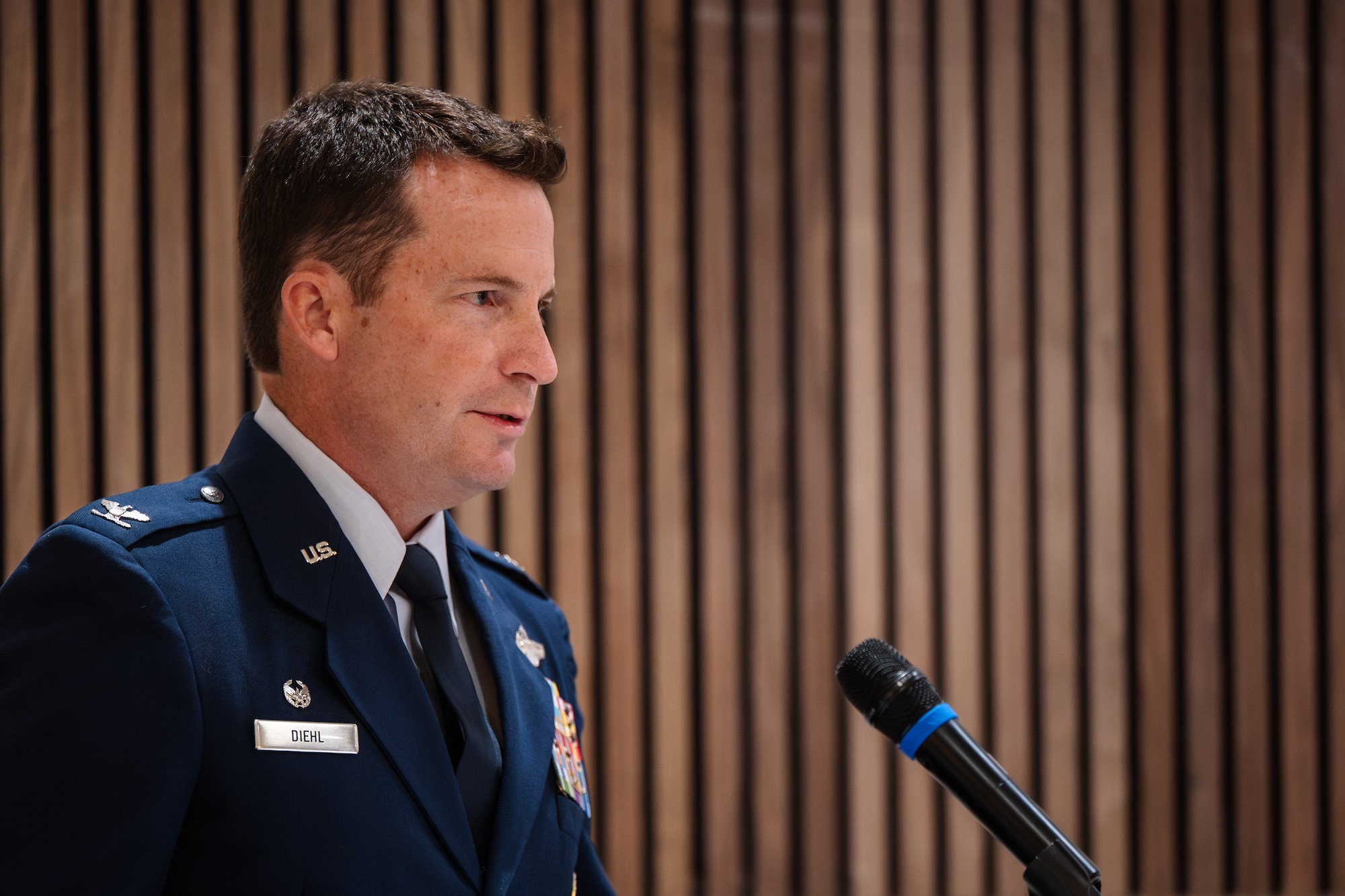 U.S. Air Force Col. Justin Diehl, 317th Airlift Wing commander, gives remarks as the presiding officer during a change of responsibilities ceremony at Dyess Air Force Base, Texas, June 12, 2026. During the ceremony the responsibilities of senior enlisted leader for the 317th AW changed from Chief Master Sgt. Martin Castillo to Brian Castillo. (U.S. Air Force photo by Senior Airman Jade M. Caldwell)