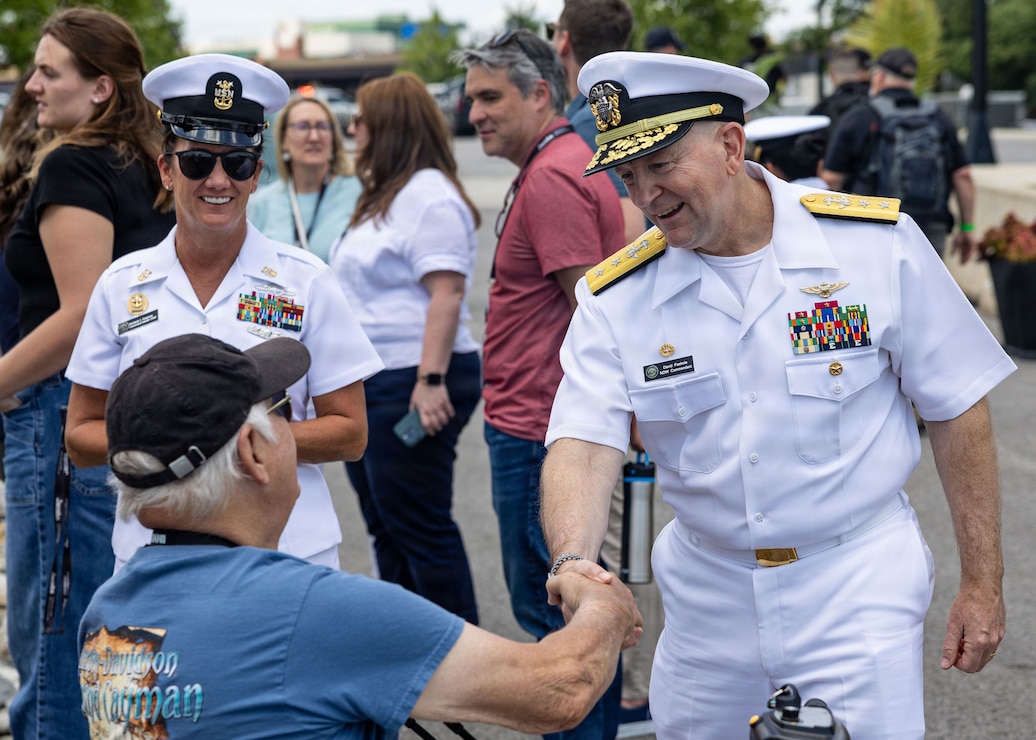 Rear Adm. David Faehnle, commandant of Naval District Washington, interacts with civilians, during SAIL250 Maryland & Airshow Baltimore.