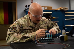 Senior Airman Eric Santiago troubleshoots radio equipment.